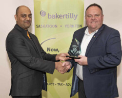 Mr. Mike's Steakhouse Casual accepts the Community Involvement Award sponsored by Cornerstone Credit Union from Doug Jones