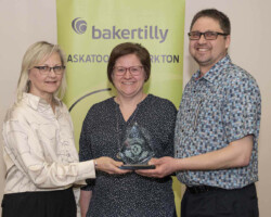 Connie Brown from Parkland College presents the Award of Excellence to Truck Pro