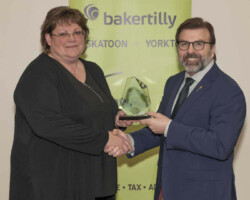 Yorkton Exhibition Association accepts the Community Merit Award sponsored by SaskTel from Greg Ottenbreit, MLA