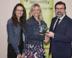 Yorkton Nursery School Cooperative accepts the Community Merit Award from Greg Ottenbreit. MLA on behalf of SaskTel